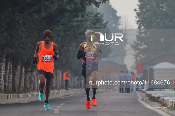 Participants run during the Kashmir Marathon on the banks of Dal Lake in Srinagar, Jammu and Kashmir, on October 20, 2024. Kashmir hosts its...