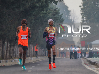 Participants run during the Kashmir Marathon on the banks of Dal Lake in Srinagar, Jammu and Kashmir, on October 20, 2024. Kashmir hosts its...