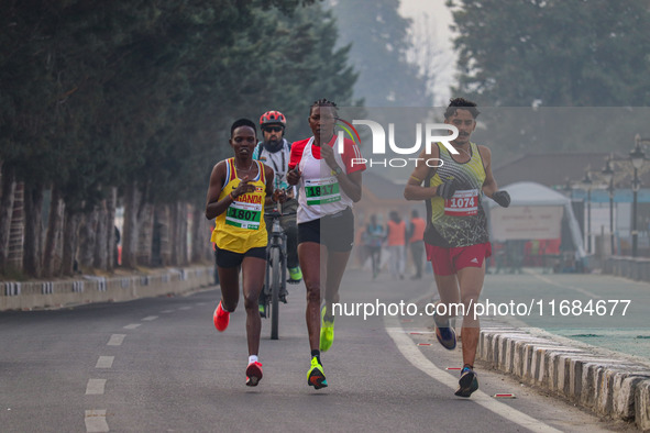 Participants run during the Kashmir Marathon on the banks of Dal Lake in Srinagar, Jammu and Kashmir, on October 20, 2024. Kashmir hosts its...