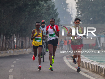 Participants run during the Kashmir Marathon on the banks of Dal Lake in Srinagar, Jammu and Kashmir, on October 20, 2024. Kashmir hosts its...