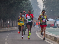 Participants run during the Kashmir Marathon on the banks of Dal Lake in Srinagar, Jammu and Kashmir, on October 20, 2024. Kashmir hosts its...