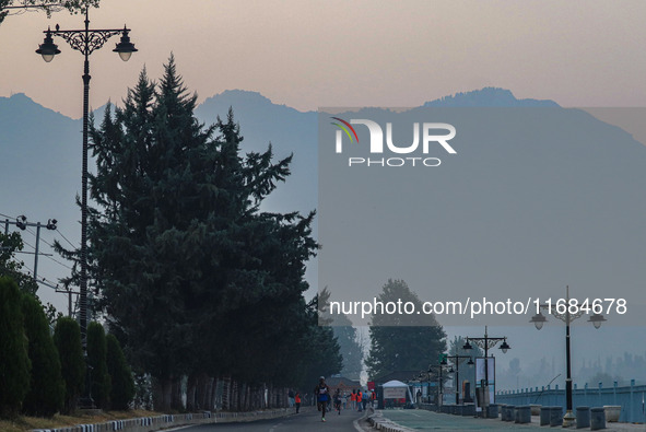 Participants run during the Kashmir Marathon on the banks of Dal Lake in Srinagar, Jammu and Kashmir, on October 20, 2024. Kashmir hosts its...