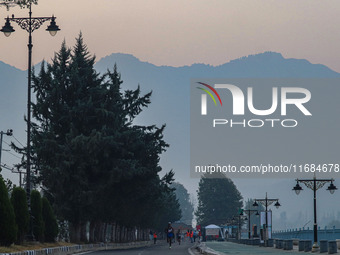 Participants run during the Kashmir Marathon on the banks of Dal Lake in Srinagar, Jammu and Kashmir, on October 20, 2024. Kashmir hosts its...