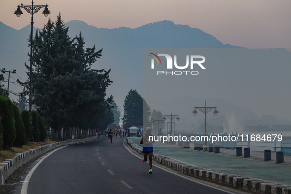 Participants run during the Kashmir Marathon on the banks of Dal Lake in Srinagar, Jammu and Kashmir, on October 20, 2024. Kashmir hosts its...