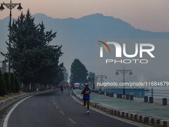 Participants run during the Kashmir Marathon on the banks of Dal Lake in Srinagar, Jammu and Kashmir, on October 20, 2024. Kashmir hosts its...