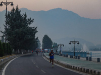 Participants run during the Kashmir Marathon on the banks of Dal Lake in Srinagar, Jammu and Kashmir, on October 20, 2024. Kashmir hosts its...