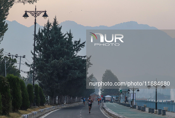 Participants run during the Kashmir Marathon on the banks of Dal Lake in Srinagar, Jammu and Kashmir, on October 20, 2024. Kashmir hosts its...