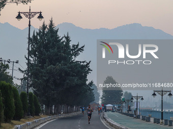 Participants run during the Kashmir Marathon on the banks of Dal Lake in Srinagar, Jammu and Kashmir, on October 20, 2024. Kashmir hosts its...