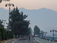 Participants run during the Kashmir Marathon on the banks of Dal Lake in Srinagar, Jammu and Kashmir, on October 20, 2024. Kashmir hosts its...