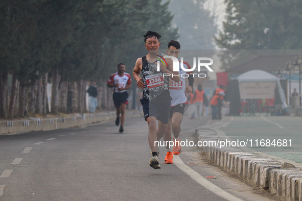 Participants run during the Kashmir Marathon on the banks of Dal Lake in Srinagar, Jammu and Kashmir, on October 20, 2024. Kashmir hosts its...