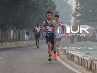 Participants run during the Kashmir Marathon on the banks of Dal Lake in Srinagar, Jammu and Kashmir, on October 20, 2024. Kashmir hosts its...