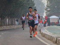 Participants run during the Kashmir Marathon on the banks of Dal Lake in Srinagar, Jammu and Kashmir, on October 20, 2024. Kashmir hosts its...