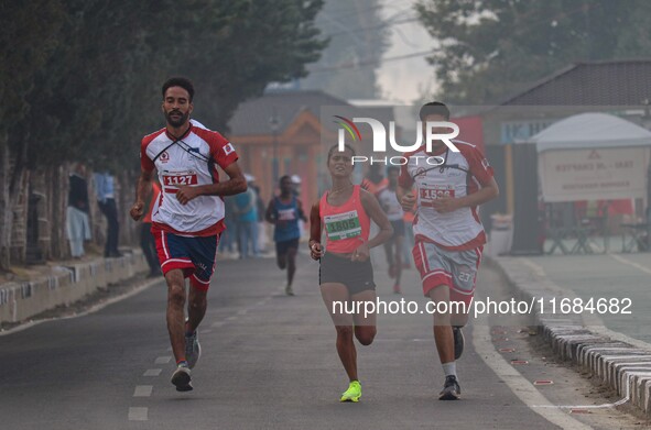 Participants run during the Kashmir Marathon on the banks of Dal Lake in Srinagar, Jammu and Kashmir, on October 20, 2024. Kashmir hosts its...