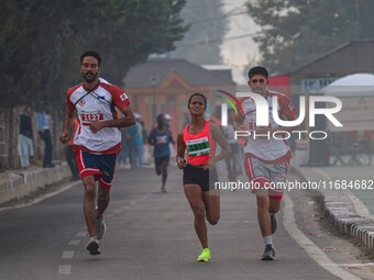 Participants run during the Kashmir Marathon on the banks of Dal Lake in Srinagar, Jammu and Kashmir, on October 20, 2024. Kashmir hosts its...