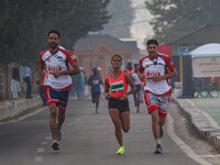 Participants run during the Kashmir Marathon on the banks of Dal Lake in Srinagar, Jammu and Kashmir, on October 20, 2024. Kashmir hosts its...