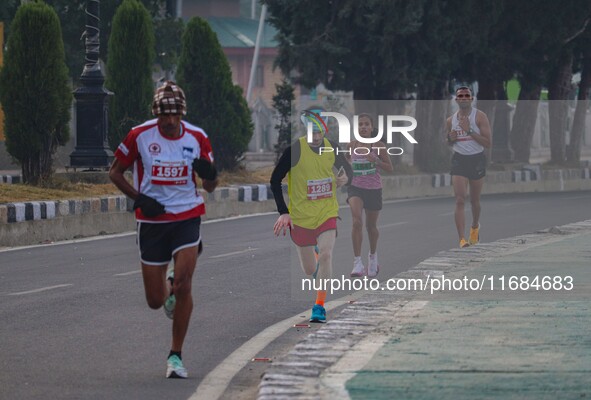 Participants run during the Kashmir Marathon on the banks of Dal Lake in Srinagar, Jammu and Kashmir, on October 20, 2024. Kashmir hosts its...