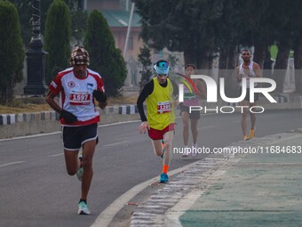 Participants run during the Kashmir Marathon on the banks of Dal Lake in Srinagar, Jammu and Kashmir, on October 20, 2024. Kashmir hosts its...