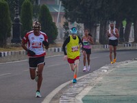 Participants run during the Kashmir Marathon on the banks of Dal Lake in Srinagar, Jammu and Kashmir, on October 20, 2024. Kashmir hosts its...