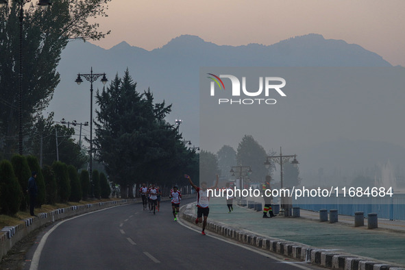 Participants run during the Kashmir Marathon on the banks of Dal Lake in Srinagar, Jammu and Kashmir, on October 20, 2024. Kashmir hosts its...