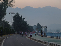 Participants run during the Kashmir Marathon on the banks of Dal Lake in Srinagar, Jammu and Kashmir, on October 20, 2024. Kashmir hosts its...