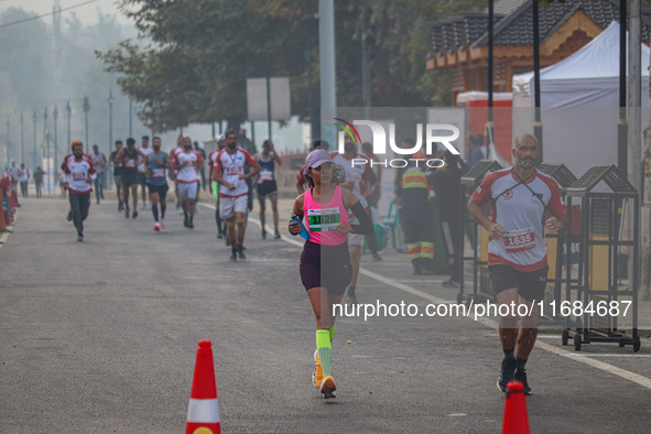 Participants run during the Kashmir Marathon on the banks of Dal Lake in Srinagar, Jammu and Kashmir, on October 20, 2024. Kashmir hosts its...