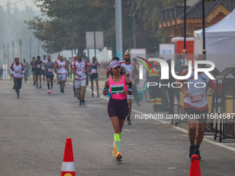 Participants run during the Kashmir Marathon on the banks of Dal Lake in Srinagar, Jammu and Kashmir, on October 20, 2024. Kashmir hosts its...