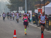 Participants run during the Kashmir Marathon on the banks of Dal Lake in Srinagar, Jammu and Kashmir, on October 20, 2024. Kashmir hosts its...