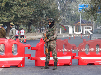 An Indian paramilitary soldier stands alert during the Kashmir Marathon in Srinagar, Jammu and Kashmir, on October 20, 2024. Kashmir hosts i...