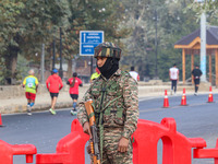 An Indian paramilitary soldier stands alert during the Kashmir Marathon in Srinagar, Jammu and Kashmir, on October 20, 2024. Kashmir hosts i...