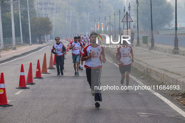 Participants run during the Kashmir Marathon on the banks of Dal Lake in Srinagar, Jammu and Kashmir, on October 20, 2024. Kashmir hosts its...