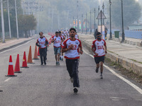 Participants run during the Kashmir Marathon on the banks of Dal Lake in Srinagar, Jammu and Kashmir, on October 20, 2024. Kashmir hosts its...