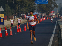 A participant runs during the Kashmir Marathon on the banks of Dal Lake in Srinagar, Jammu and Kashmir, on October 20, 2024. Kashmir hosts i...