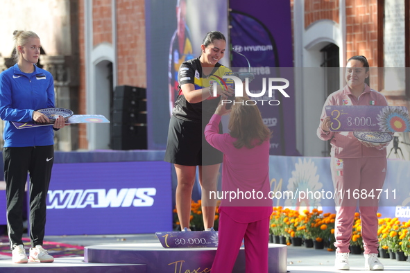 (L-R) Silver medalist Meeri-Marita Paas of Estonia, gold medalist Sara Lopez of Colombia, and bronze medalist Dafne Quintero of Mexico parti...