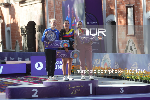 (L-R) Silver medalist Meeri-Marita Paas of Estonia, gold medalist Sara Lopez of Colombia, and bronze medalist Dafne Quintero of Mexico parti...