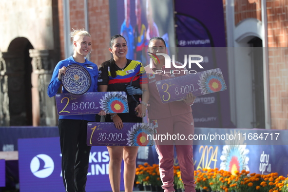 (L-R) Silver medalist Meeri-Marita Paas of Estonia, gold medalist Sara Lopez of Colombia, and bronze medalist Dafne Quintero of Mexico parti...