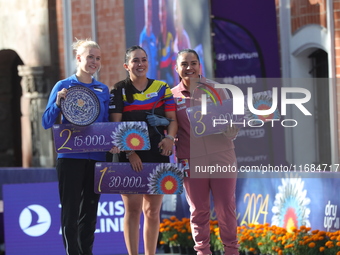 (L-R) Silver medalist Meeri-Marita Paas of Estonia, gold medalist Sara Lopez of Colombia, and bronze medalist Dafne Quintero of Mexico parti...