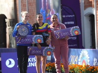 (L-R) Silver medalist Meeri-Marita Paas of Estonia, gold medalist Sara Lopez of Colombia, and bronze medalist Dafne Quintero of Mexico parti...