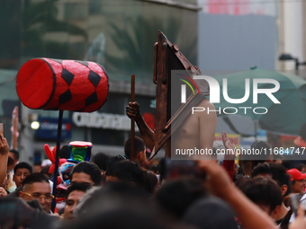 A person in disguise takes part in the annual Zombie walk from the Monument to the Revolution to the main square Zocalo in Mexico City, Mexi...