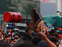 A person in disguise takes part in the annual Zombie walk from the Monument to the Revolution to the main square Zocalo in Mexico City, Mexi...