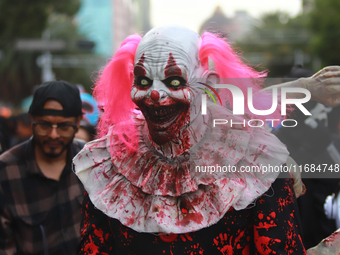 A person disguised as a clown takes part in the annual Zombie Walk from the Monument to the Revolution to the main square Zocalo in Mexico C...