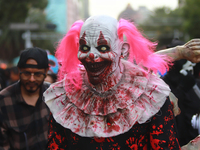 A person disguised as a clown takes part in the annual Zombie Walk from the Monument to the Revolution to the main square Zocalo in Mexico C...