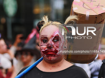 A person in disguise takes part in the annual Zombie walk from the Monument to the Revolution to the main square Zocalo in Mexico City, Mexi...