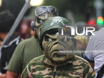 A person in disguise takes part in the annual Zombie walk from the Monument to the Revolution to the main square Zocalo in Mexico City, Mexi...