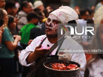 A person in disguise takes part in the annual Zombie walk from the Monument to the Revolution to the main square Zocalo in Mexico City, Mexi...