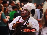 A person in disguise takes part in the annual Zombie walk from the Monument to the Revolution to the main square Zocalo in Mexico City, Mexi...