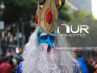 A person in disguise takes part in the annual Zombie walk from the Monument to the Revolution to the main square Zocalo in Mexico City, Mexi...