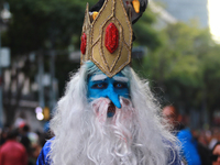 A person in disguise takes part in the annual Zombie walk from the Monument to the Revolution to the main square Zocalo in Mexico City, Mexi...