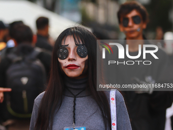 A person in disguise takes part in the annual Zombie walk from the Monument to the Revolution to the main square Zocalo in Mexico City, Mexi...