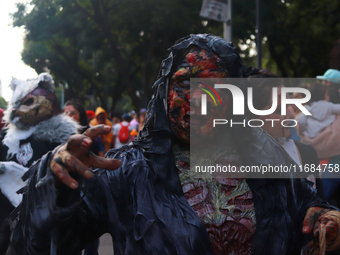 A person in disguise takes part in the annual Zombie walk from the Monument to the Revolution to the main square Zocalo in Mexico City, Mexi...