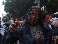 A person in disguise takes part in the annual Zombie walk from the Monument to the Revolution to the main square Zocalo in Mexico City, Mexi...